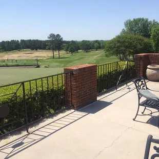 The balcony of the clubhouse overlooking the putting green, driving range and the starting hole