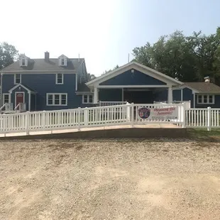 a blue house with a white picketer