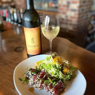 a plate of food and a glass of wine