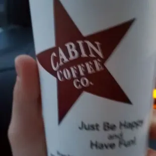 a hand holding a cup of coffee