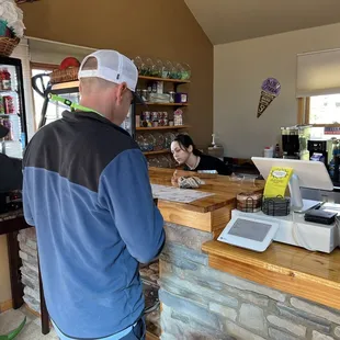 two men standing at a counter