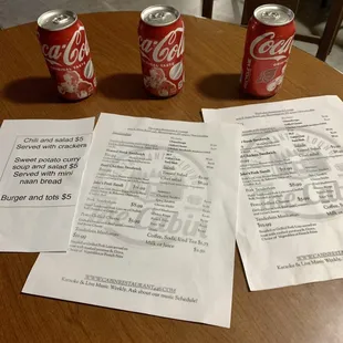 Specials, Menu, and chilled cans of Coca Cola.