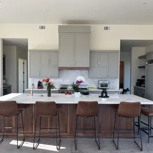 Island is a beautiful walnut with the light gray cabinets and gold accents