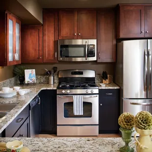 Two Tone Kitchen with Koch Cabinets, Brandy and Java finish with stainless range and microwave vent.