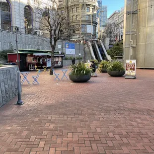 two people walking down a brick walkway