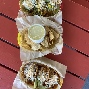 Fish tacos with cabbage and mango salsa, smoked cheddar and cilantro tomatillo, side of chips and cheese sauce.