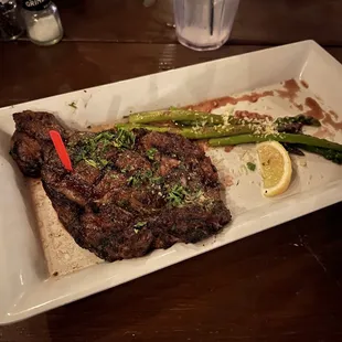 Ribeye rare with a side of asparagus and a house salad