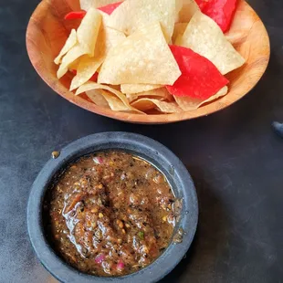 a bowl of salsa and chips