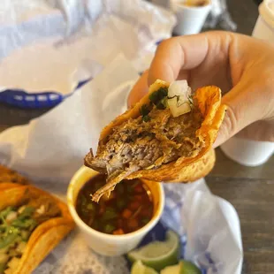 a hand holding a piece of food