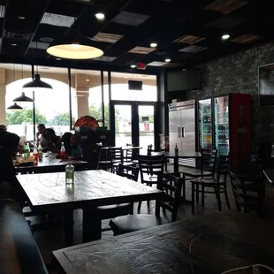 people sitting at tables in a restaurant