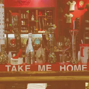a bar with a sign that says take me home