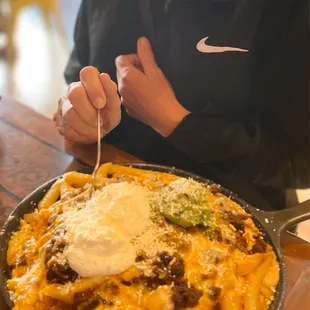 Who eats their fries with a fork too? Carne Asada fries added guacamole and jalapeños.
