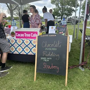 a chalkboard sign with a strawberry on it