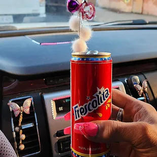 a person holding a can of pepsi