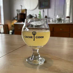 a glass of cid on a table