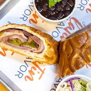 Cacho&apos;s Bread Sandwich comes w/ two sides ($14.50)