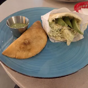 One chicken avocado and cheese Areapa and one beef green chile cheese Empanada