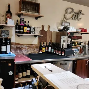 a bar with bottles of wine on the counter