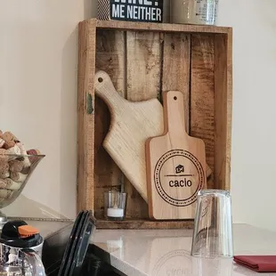 a kitchen counter with utensils and a cutting board