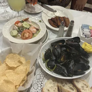 Platinos, chips and salsa, ceviche, and mussels appetizer.