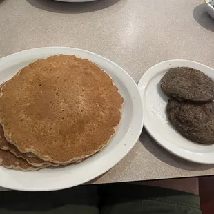 Huge multigrain pancakes and sausage patties.