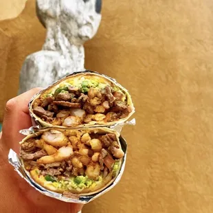 Surf N Turf burrito: ribeye, shrimp, French fries, house made guac and pico with fried cheese.