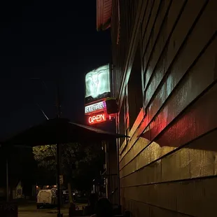 a neon sign on the side of a building