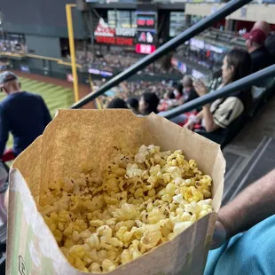 a person holding a bag of popcorn