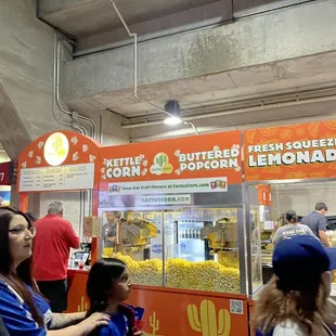 people standing in line at a food stand