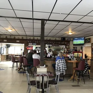people sitting at tables in a restaurant
