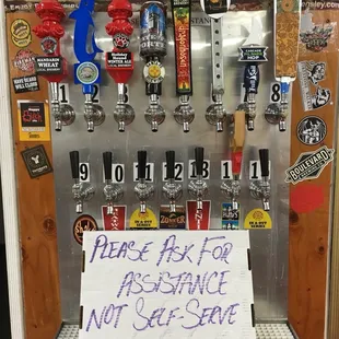 a beer dispenser with a sign on it