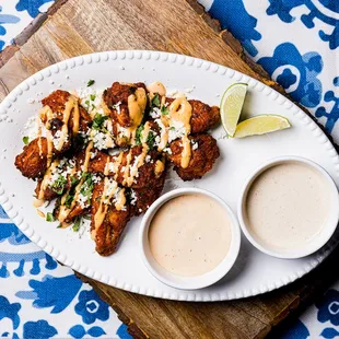 a plate of chicken wings with dipping sauce