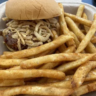BBQ brisket with pickle and fried crispy onions.