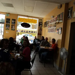 people sitting at tables in a restaurant