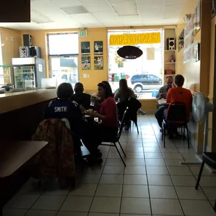 people sitting at tables in a restaurant