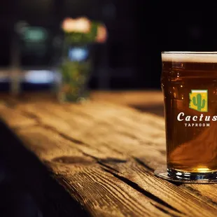 a pint of beer on a wooden table