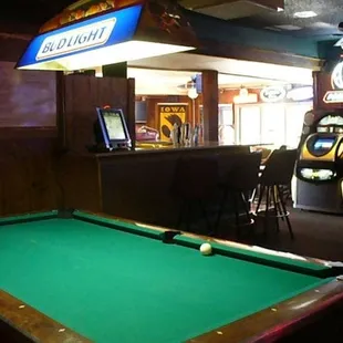 a pool table and arcade machines