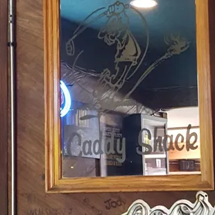 a reflection of a sign in a mirror