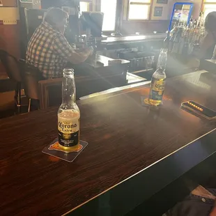 two people sitting at a bar