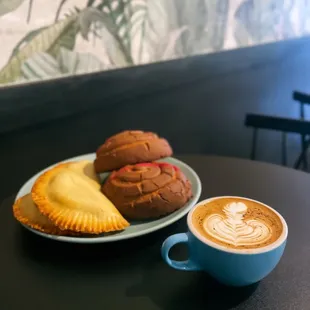 a plate of pastries and a cup of cappuccino