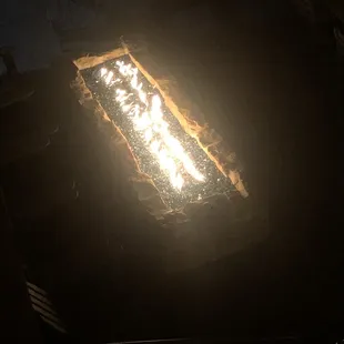 Outdoor patio glass fireplace.