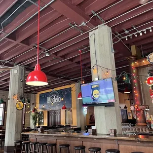 a bar with a television and bar stools