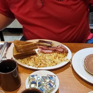 Sampler was 3 eggs, hashbrowns, grits, bacon, sausage links and ham. With a side of hotcakes. It had several options, ordered them all...