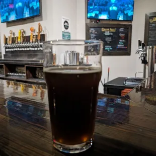 a pint of beer on a bar