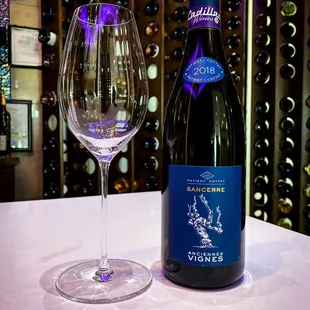 a bottle and a glass of wine