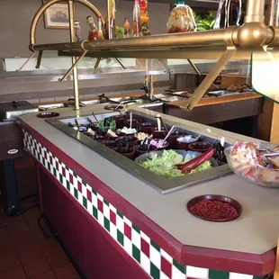 a buffet with salads and condiments
