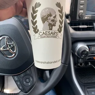 a hand holding a cup of coffee