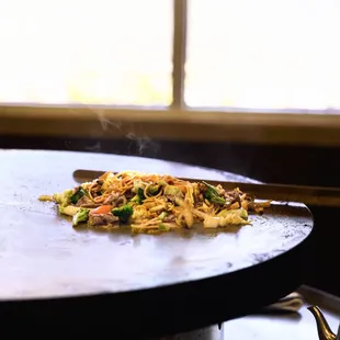 ows a plate of food being prepared