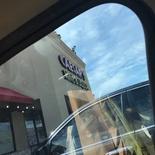 the reflection of a car in the window