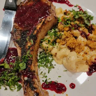 Tomahawk pork chop with a blackberry bourbon glaze and spicy mac &amp; cheese.